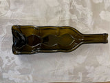 Slumped wine bottle candle holder.