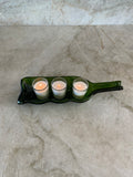 Slumped wine bottle candle holder.