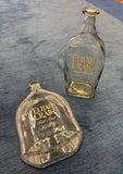 Slumped Elijah Craig bourbon bottle