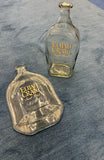 Slumped Elijah Craig bourbon bottle