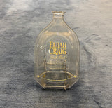 Slumped Elijah Craig bourbon bottle