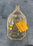Slumped Elijah Craig bourbon bottle