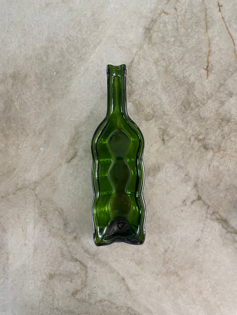 Slumped wine bottle candle holder.