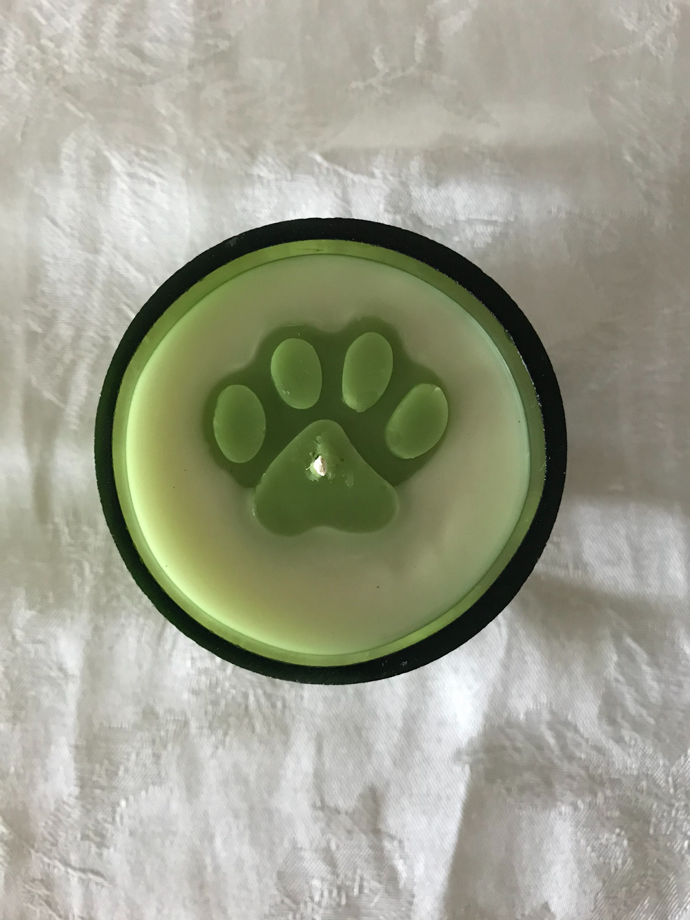 Recycled green wine bottle candle with embedded paw print